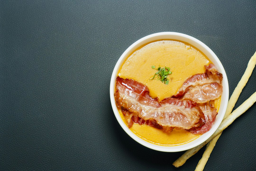 Creamy bowl of soup topped with bacon, illustrating potato soup