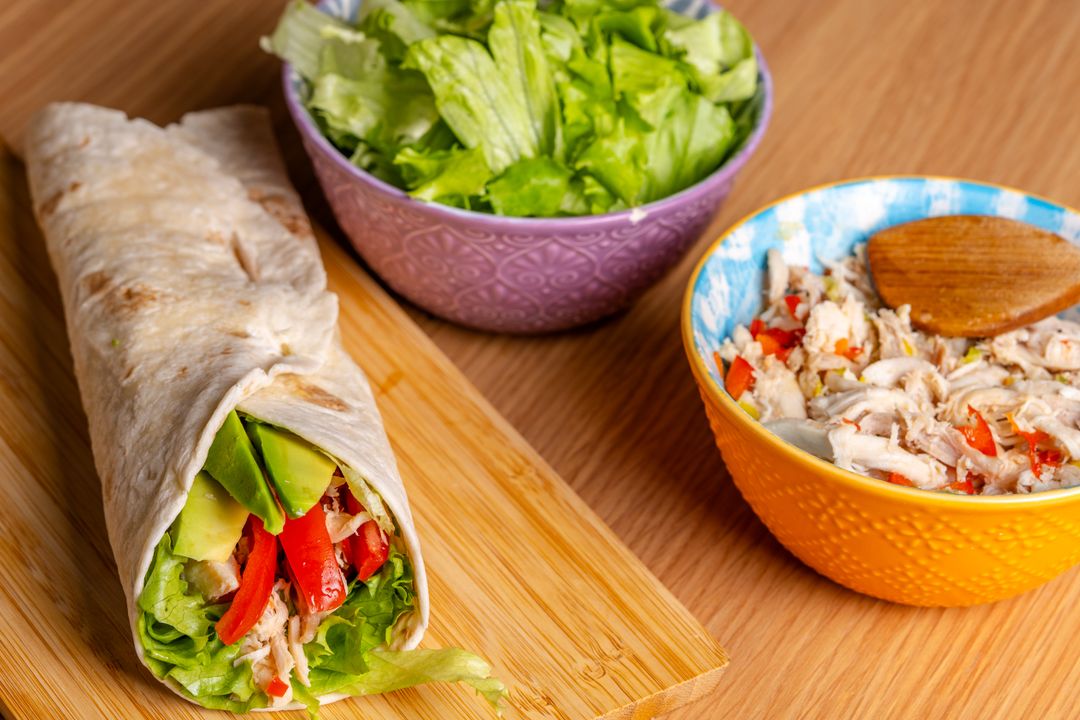 Chicken wraps filled with avocado and fresh vegetables